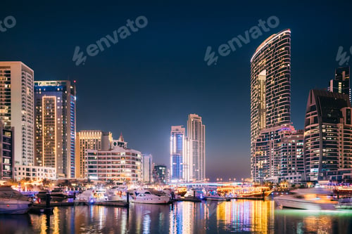 Preview: Beautiful Night View Of Dubai Marina Skyline. Yachts Moored Near City Pier, Jetty In Evening Night