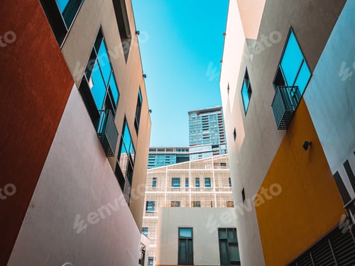 Preview: Low angle shot of modern buildings on a blue sky background