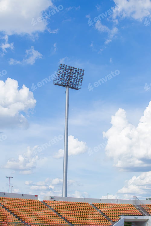 Preview: Big spotlights lighting tower at an sport arena stadium sky background