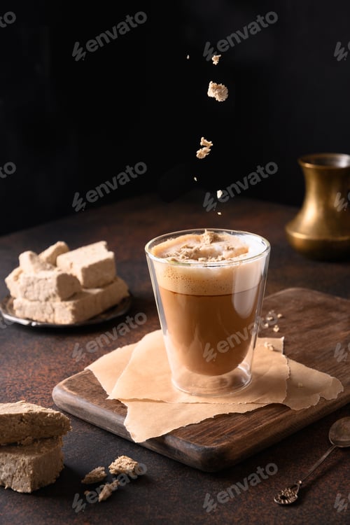 Preview: Tasty coffee latte with halva in glass cup.