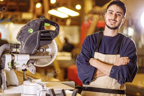 Preview: portrait of positive smiling carpenter at work place