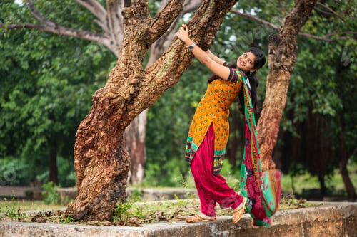 Preview: Young girl near tree trunk and she enjoying fresh air outdoors