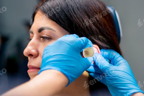 Preview: close-up ENT doctor examines the patient's ears in the office clinic with professional instruments