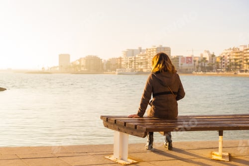 Preview: A young tourist girl at sunset on Playa del Cura in the coastal town of Torrevieja