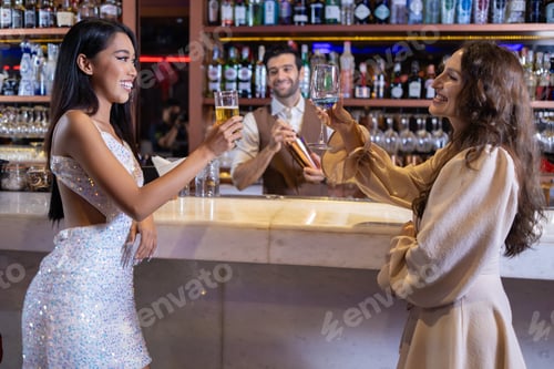 Preview: Women Friends Enjoying Drinks at Elegant Bar