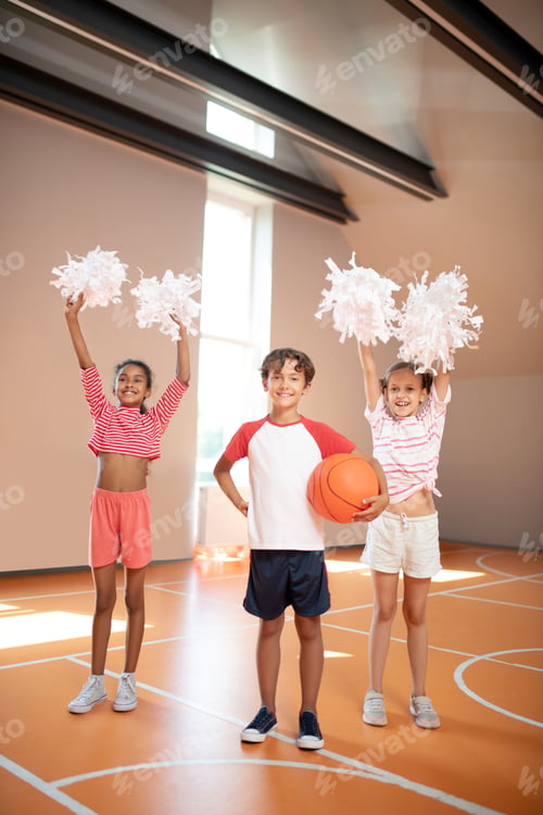 Preview: Girls practicing cheerleading standing near classmate