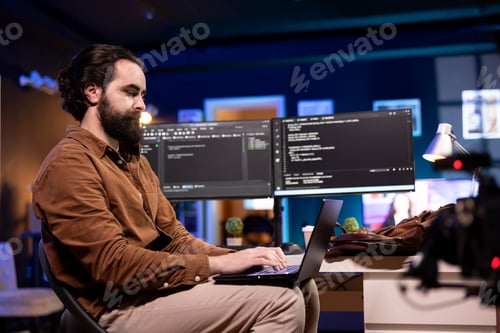 Preview: Programmer doing software debugging using laptop, checking errors in code