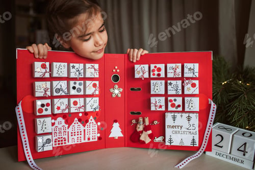 Preview: Pretty girl holds original advent calendar made of jewelry boxes and binder, Christmas diy craft