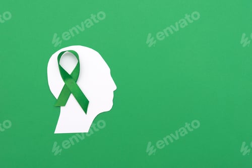 Preview: white paper Silhouette of a Human Head with Green Ribbon on Green Background
