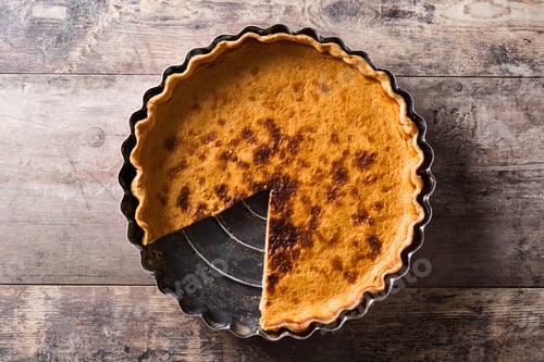 Preview: Delicious pumpkin pie on rustic wooden table with missing slice