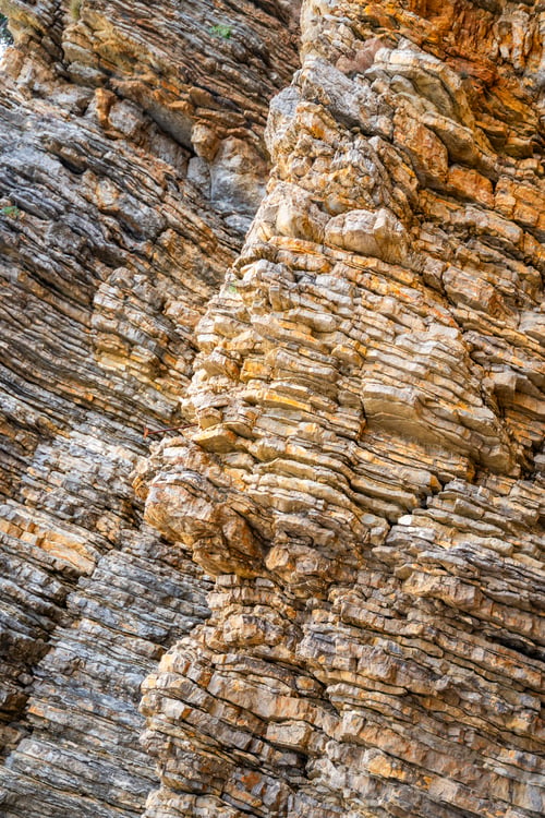 Preview: Layered rock texture in Budva, Montenegro. Sedimentary rocks with rugged surface of gray and brown