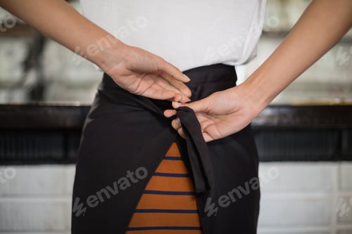 Preview: Close up of waitress tying apron
