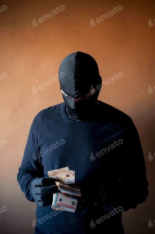 Preview: Robber with black gloves counting a handful of euro bills