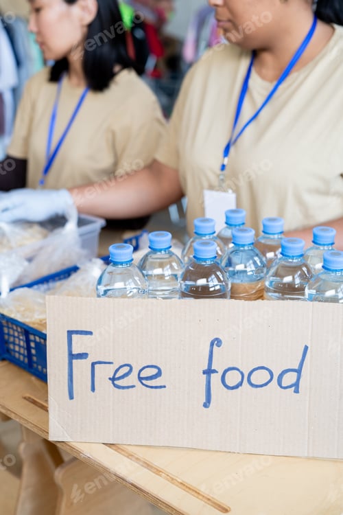 Preview: Female volunteers donating free food and plastic bottles with water