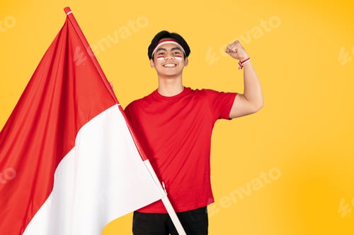 Preview: Cheerful Young Man Holding a Flag in Studio