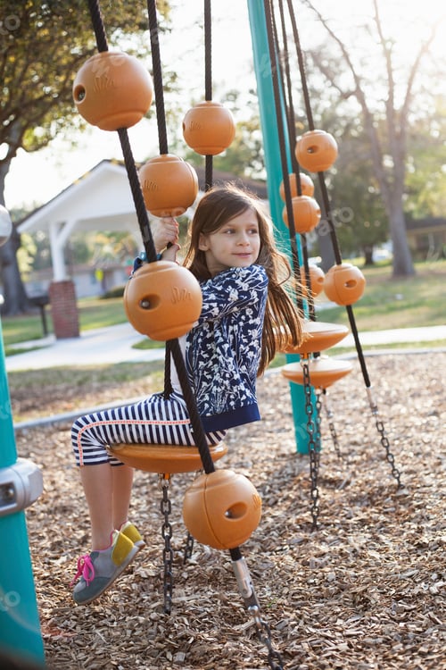 Preview: Girl playing swing in playground