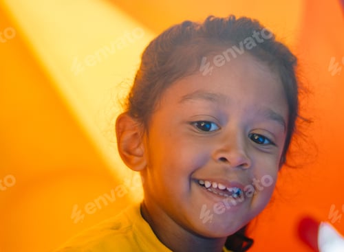 Preview: A little girl on a yellow play scape