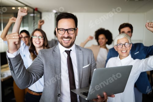 Preview: Business team celebrating a good job in the office