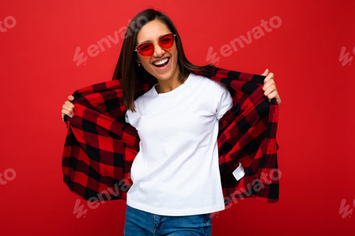 Preview: Positive happy smiling young brunette woman in casual white t-shirt for mockup, stylish red check