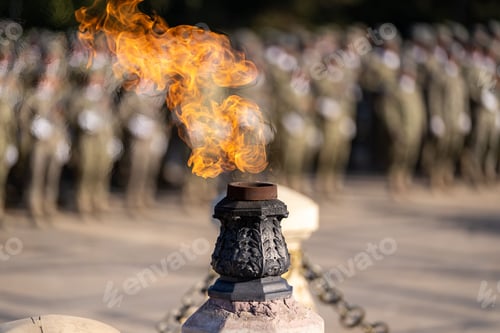 Preview: Eternal flame burning brightly with blurred soldiers in the background