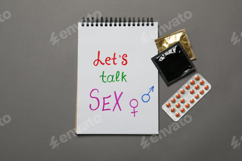Preview: Notebook with Let's talk Sex, condoms and pills on gray background