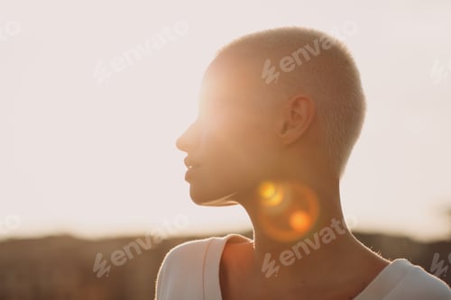 Preview: Millenial young woman blonde short hair outdoor smiling portrait.