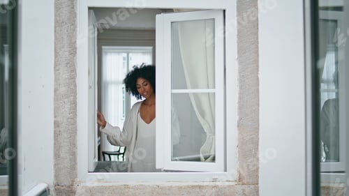 Preview: African model closed window living room. Happy woman spending morning at home