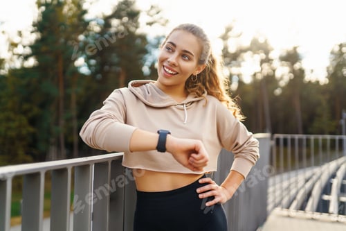 Preview: Young woman in sportswear is training outdoors. Sports concept, healthy body.