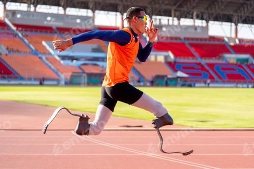 Preview: Asian para-athletes with prosthetic blades sprint on a running track at stadium.
