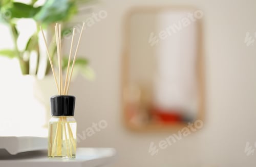 Preview: Aromatic reed air freshener on table against blurred background