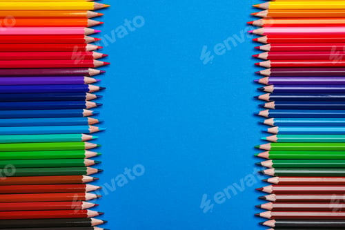 Preview: Color pencils on blue background, flat lay. Space for text