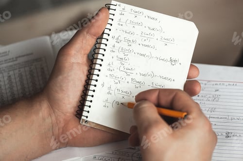 Preview: Math formulas are written in pencil in a notebook holding man in