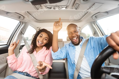 Preview: Excited black couple enjoying music driving luxury car