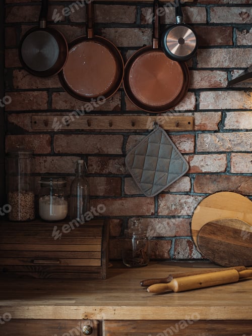 Preview: beautiful kitchen with red brick wall and a lot of copper and wood kitchen utensils