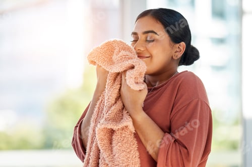 Preview: Woman smelling clean laundry, blanket or fabric for fresh and clean smell in house after doing wash