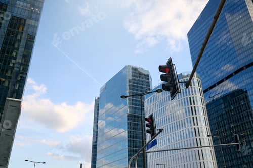 Preview: Urban skyline with modern skyscrapers and red traffic lights