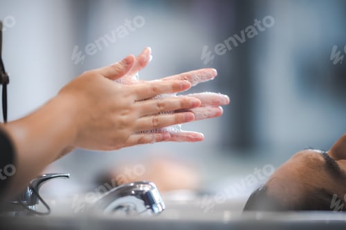 Preview: hairdresser washing client's hair at salon. happy customer relax and comfortable while washing hair