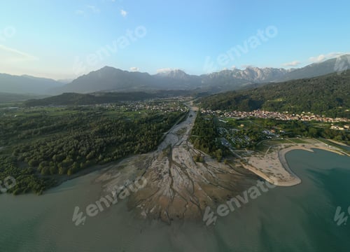 Preview: Aerial view of a scenic landscape with mountains and a river.