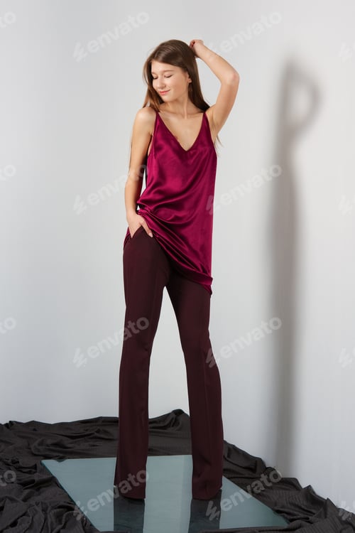 Preview: Attractive fashion model in pants and blouse on straps.