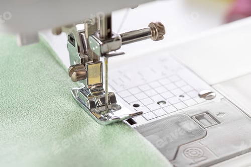Preview: Modern Sewing Machine Presser Foot With Green Fabric And Thread, Closeup, Macro