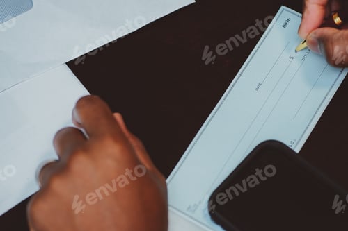 Preview: African American man writing out a check