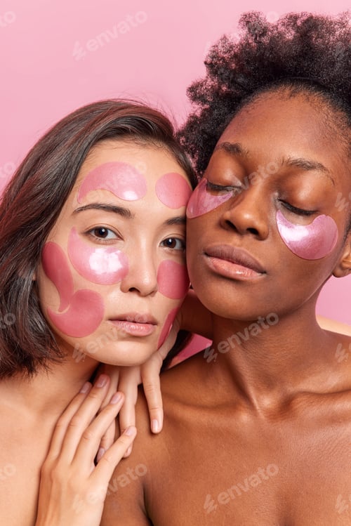 Preview: Close up shot of serious two women with naked body healthy skin apply hydrogel patches on face and u