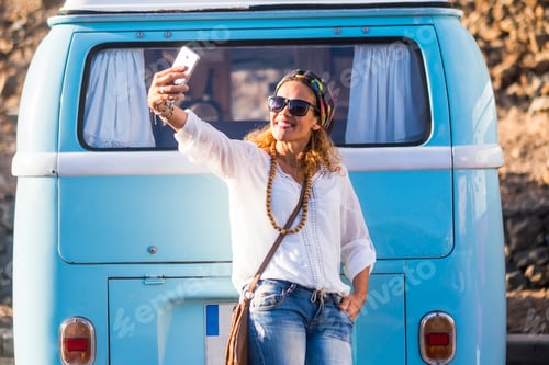Preview: Cheerful caucasian 40 years old woman smile and take a selfie picture with phone cell