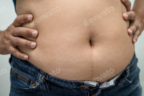 Preview: Overweight Asian woman show and use hand to squeeze fat belly.