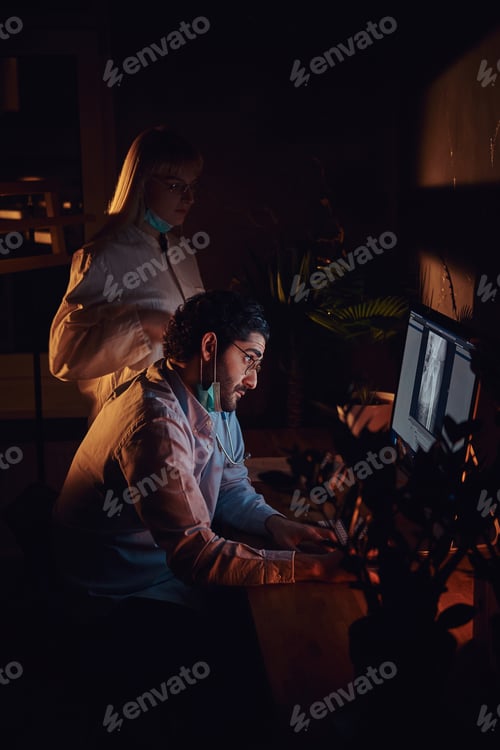 Preview: Two docters are working in the dark office