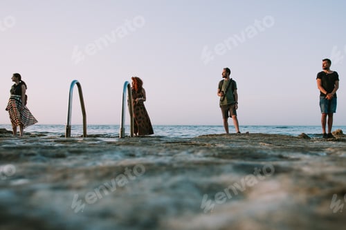 Preview: Couple of friends walking by the sea