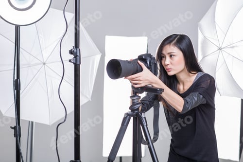 Preview: Photographer taking picture in studio
