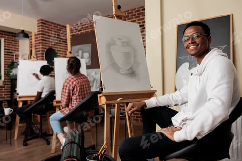 Preview: Happy African student guy of art school