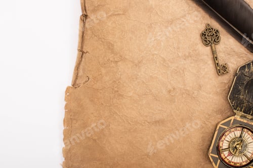 Preview: top view of feather, vintage key and compass on aged paper isolated on white