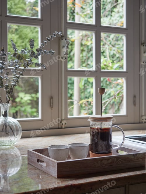 Preview: French press coffee maker, with infusion and two cups on a tray on the kitchen counter